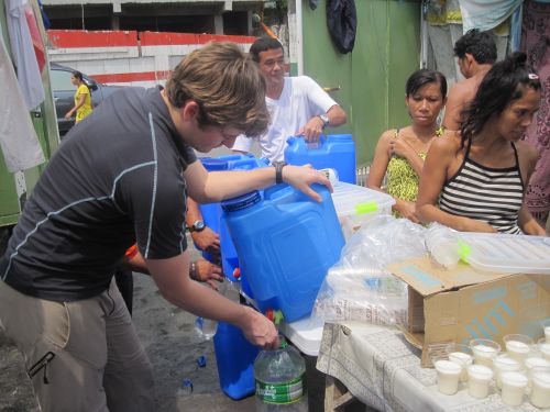 Pat Refilling Resident's Water Containers